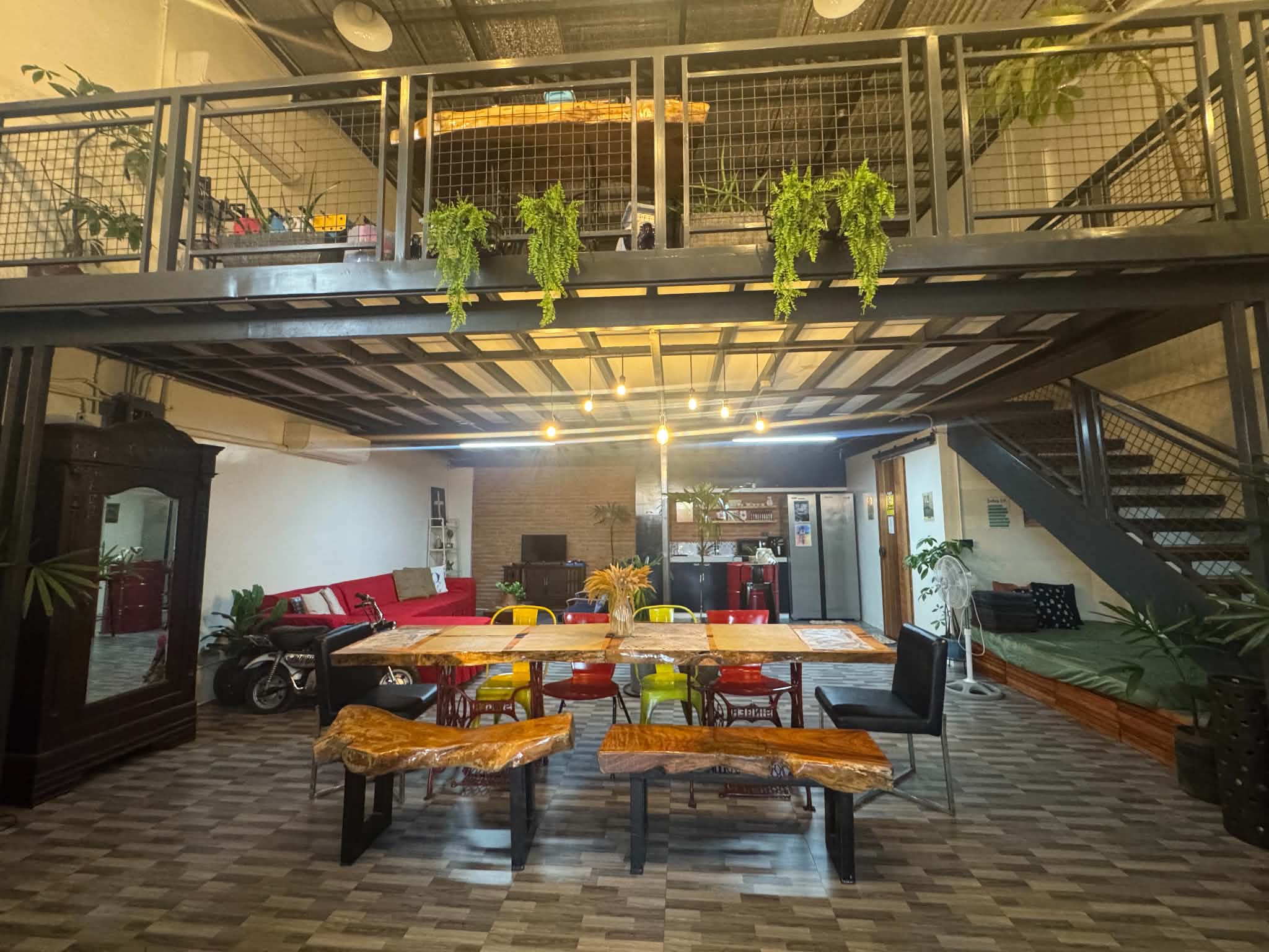 Casa Verde indoor dining area with wooden table, benches and loft above