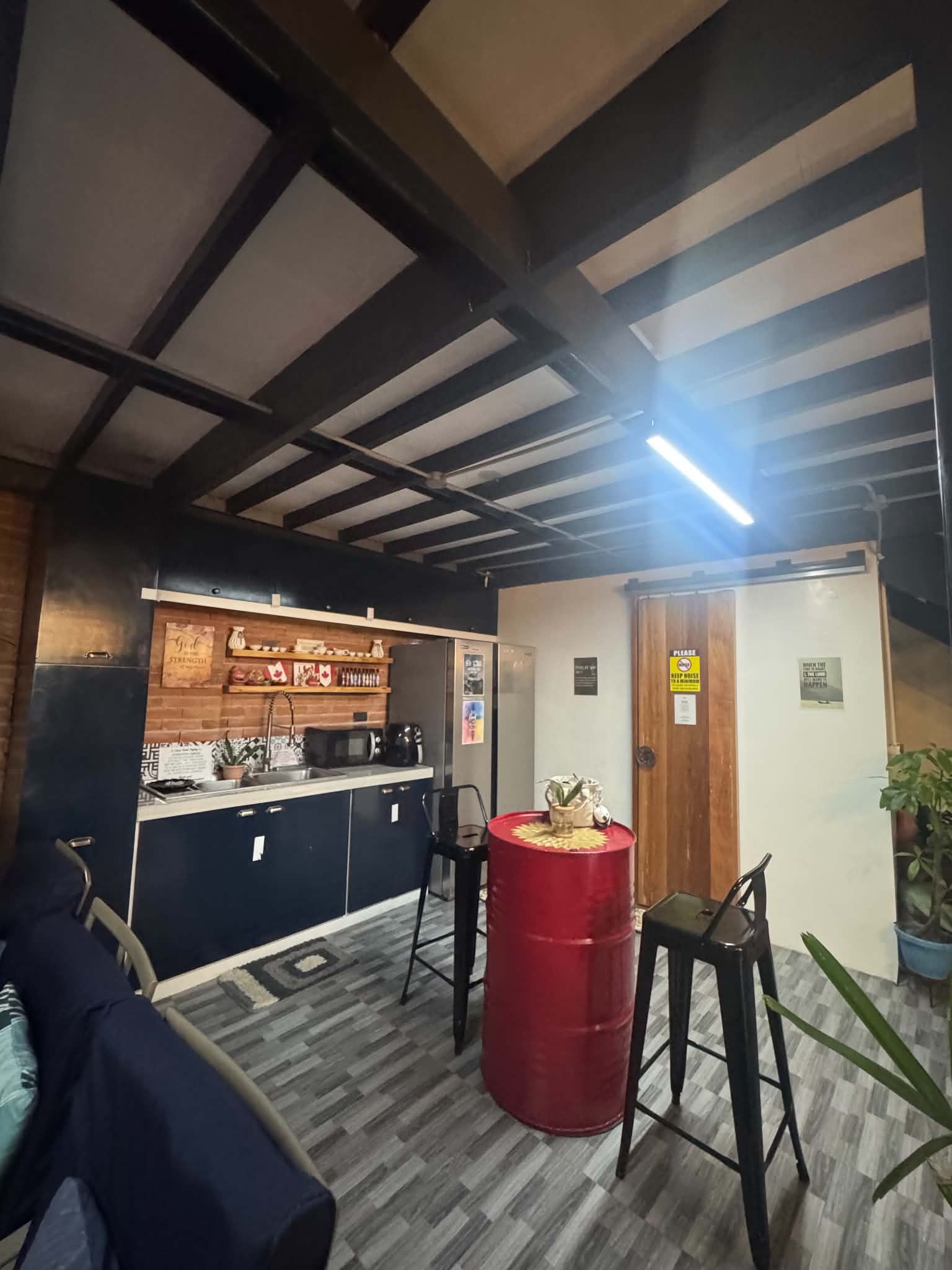 Casa Verde indoor kitchen with sink, refrigerator, counter and bar seating